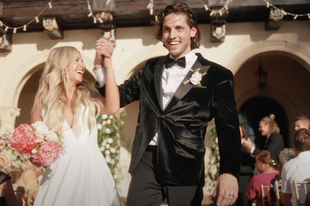 Groom in black tuxedo and bow tie at a wedding ceremony, showing formal wedding attire and answering can i wear black to a wedding